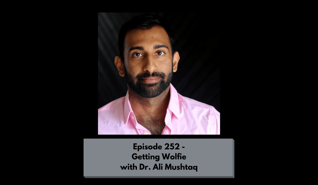A headshot of Dr. Ali Mushtaq, kink and diversity educator, in front of a black background. Text reads: Episode 252 - Getting Wolfie with Dr. Ali Mushtaq