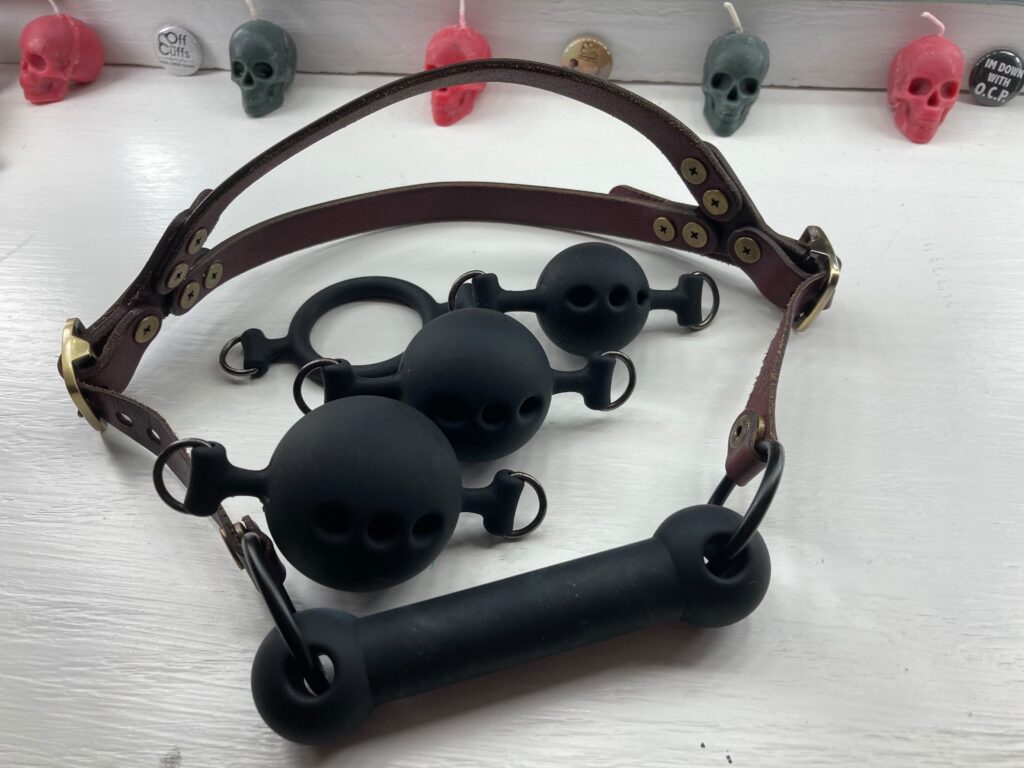 A five-piece gag set with three ball sizes, a ring, and a bit gag. 